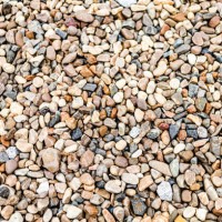 diverse collection of small pebbles and stones in various colors scattered on a surface in natural light - garden decoration stock pictures, royalty-free photos & images