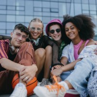 diverse group of generation z friends hanging out together outdoors in the city. - fashion stock pictures, royalty-free photos & images