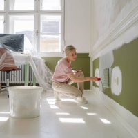 diy: a woman's painting her own apartment - home decoration stock pictures, royalty-free photos & images