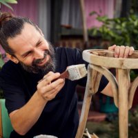 diy in the garden. man painting wooden chair - garden decoration stock pictures, royalty-free photos & images