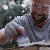 diy in the garden. man painting wooden crate - garden decoration stock pictures, royalty-free photos & images