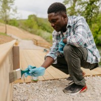 diy: painting a wooden decking next to a river - home decoration stock pictures, royalty-free photos & images