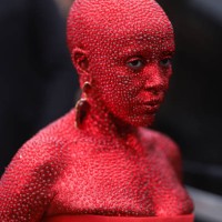 Doja Cat is seen wearing a full red glittery Look ,long dress and earrings outside Schiaparelli show, during the Paris Fashion Week - Haute Couture...