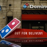 Domino's Pizza Inc. Signage is displayed outside of a restaurant in Detroit, Michigan, U.S., on Wednesday, April 27, 2016. Domino's Pizza Inc. Is...