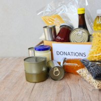 donations box with canned food on wooden table background pasta canned goods and dry food non perishable with pea cooking oil rice noodles spaghetti macaroni donations food,romania - food stock pictures, royalty-free photos &