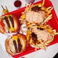 double cheeseburgers and cheese fries on a tray in fast food joint - junk food stock pictures, royalty-free photos & images