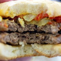 Double hamburger is seen on July 18, 2002 at a Burger King in Miami, Florida. The health effects of an American diet of super-sized fast foods are...