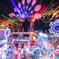 Dozens of illuminated Christmas figures and motives, as well as thousands of lights fill the front garden of a house while music completes the...