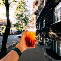 drinking iced coffee on a sunny summer day, personal perspective view - junk food stock pictures, royalty-free photos & images
