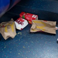 Dropped McDonalds packaging and food remains on the floor of a London bus, on 3rd October 2019, in south London, England.