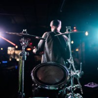 drum on stage with singer on background at nightclub - concert stock pictures, royalty-free photos & images