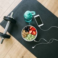 dumbbell, drinking bottle, fruit bowl and smartphone with earphones - food stock pictures, royalty-free photos & images