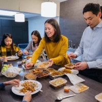 east asian family enjoying takeout food for dinner - junk food stock pictures, royalty-free photos & images