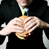 eating at the office - junk food stockfoto's en -beelden