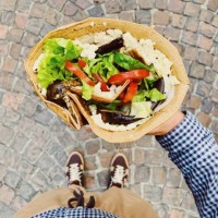 eating big french crepe pancake with vegetables, salad and cheese, personal persoective view - junk food stock pictures, royalty-free photos & images