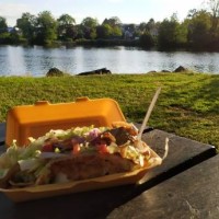 eating kebab ( take out food) close to a lake on a sunny day - junk food stock pictures, royalty-free photos & images