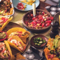 eating mexican tacos with spicy salsa and nacho tortilla chips - food stock pictures, royalty-free photos & images