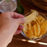 eating potato chips and drinking beer - junk food stock-fotos und bilder