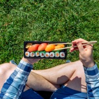 eating takeaway sushi with chopsticks at the park, personal perspective directly above view - junk food stock pictures, royalty-free photos & images