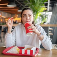 eating unhealthy fast food - junk food stock pictures, royalty-free photos & images
