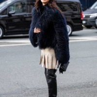 Ece Sukan wears navy faux fur jacket, beige skirt, over knees boots, sunglasses outside Dior during Haute Couture Spring-Summer 2025 as part of Paris...