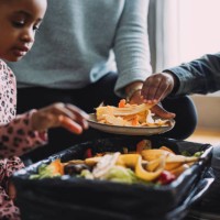 eco-friendly family bonding activity: an anonymous mother, daughter and son making compost from vegetable and fruit leftovers at home - food stock pictures, royalty-free photos & images