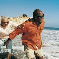 elderly couple messing about at waters edge - travel stock-fotos und bilder