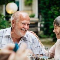 elderly couple smiling at family bbq - garden decoration stock pictures, royalty-free photos & images