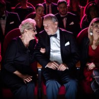 elderly couple talking while sitting in theater - concert stock pictures, royalty-free photos & images