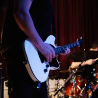 electric guitar player with rock and roll band performing hard rock music on stage - concert stock pictures, royalty-free photos & images