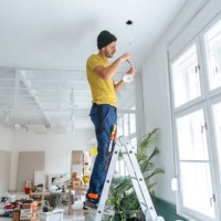 electrician fixing ceiling lights - home decoration stock pictures, royalty-free photos & images