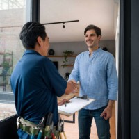 electrician greeting a client with a handshake at the door of his house - home decoration stock pictures, royalty-free photos & images