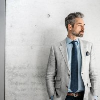 elegant handsome bearded businessman standing with dog in business district - fashion stock pictures, royalty-free photos & images