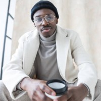 elegant young man wearing white winter coat - fashion stock pictures, royalty-free photos & images