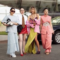 Elena Kolisnichenko wears light baby blue long maxi skirt with tassels, blue leather top, blue tights, white shoes, cow print bag and brown...