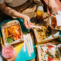 elevated view of young mother and her little girl sharing food at healthy fast-food restaurant - junk food stock pictures, royalty-free photos & images