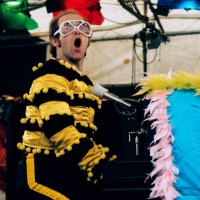 Elton John performs at an open-air concert in May 1974 in Watford, England.