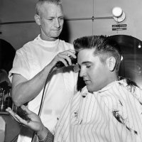 Elvis Presley receives a crew cut on his first full day as a member of the US Army.