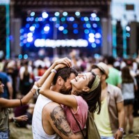 embraced couple having fun on music concert. - concert stock pictures, royalty-free photos & images