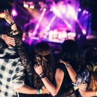 embraced friends are listening to their favorite band together at the music concert - concert stock pictures, royalty-free photos & images