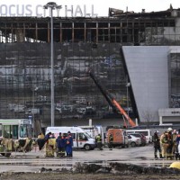 Emergency services personnel work by the burnt-out Crocus City Hall concert venue in Krasnogorsk, outside Moscow, on March 26, 2024. At least 139...