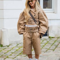 Emili Sindlev wears beige multi belted jacket, shorts, Louis Vuitton bag outside Ganni during the Womenswear Fall/Winter 2025/2026 as part of Paris...