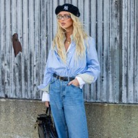 Emili Sindlev wears beret, blue button shirt, denim jeans, black bag outside Cos during New York Fashion Week on September 10, 2024 in New York City.