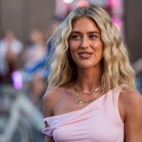 Emili Sindlev wears pink asymmetric dress outside Tory Burch during New York Fashion Week on September 09, 2024 in New York City.