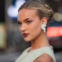 Emilia Silberg wears mint green dress, earrings outside Tory Burch during New York Fashion Week on September 09, 2024 in New York City.