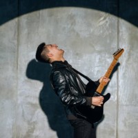 emotional man artist plays rock song on electric guitar and enjoys performing on stage. - concert stock pictures, royalty-free photos & images