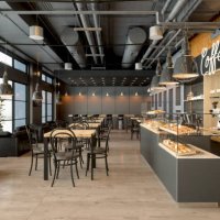 empty coffee shop interior with wooden tables, coffee maker, pastries and pendant lights - home decoration stock pictures, royalty-free photos & images