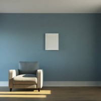 empty sunlit room with armchair and white picture frame - home decoration photos et images de collection