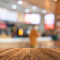 empty wooden table with fast food restaurant - junk food stock pictures, royalty-free photos & images