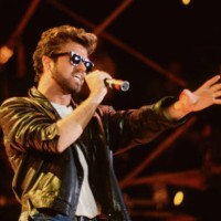 English Pop singer George Michael , of the group Wham, performs at Live Aid, Wembley Stadium, London, 7/13/1985.